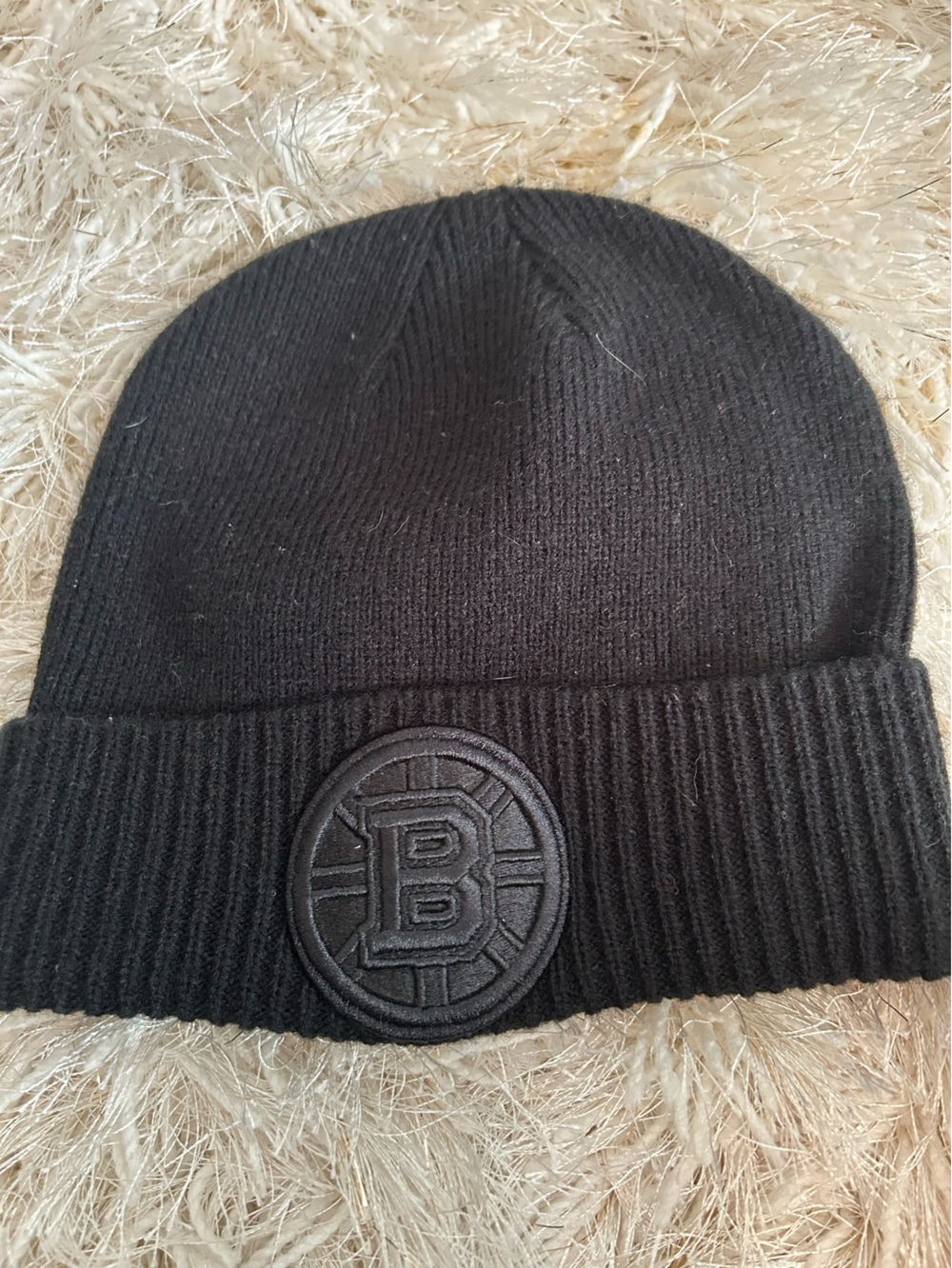 Unisex black Boston Bruins beanie with black embroidered patch